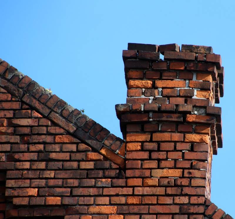 Signs Your Temple Hills Home Needs a Chimney Inspection Damaged chimney on an Temple Hills home showing cracks and missing mortar